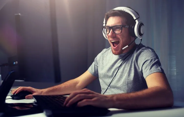 happy gamer with white headphones